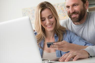 Husband with wife holding credit card
